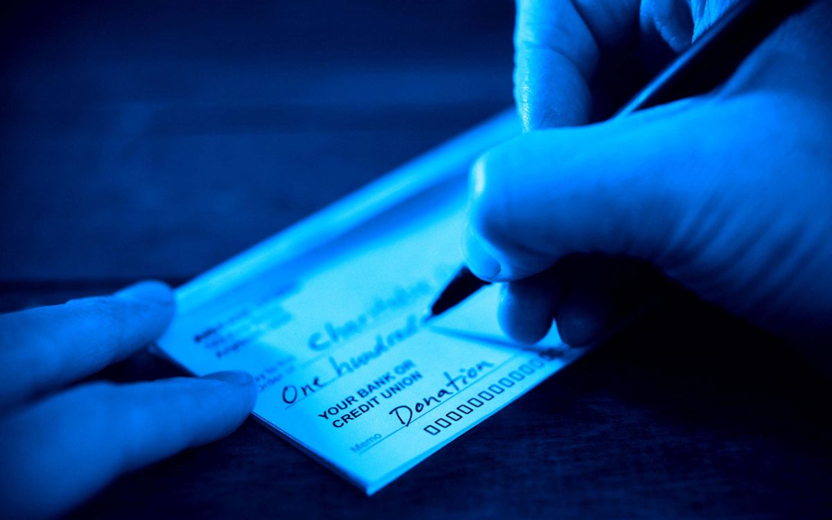 Writing a donation check to a charitable organization